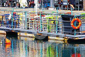 Dock with lifebuoys in the port