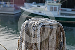 Dock side hemp hawser rope ready to be used to moor lobster boat