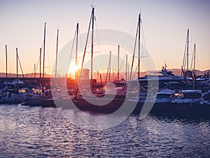 Dock with white boats and yachts on a beautiful colorful sunset