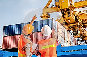 Dock worker pointing finger on control of container