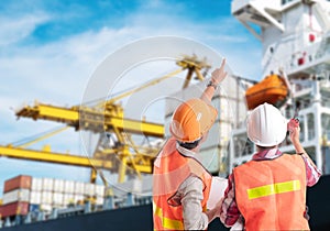 Dock worker pointing finger on control of container loading photo