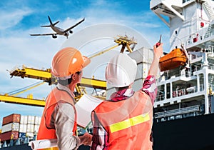 Dock worker pointing finger on control of container loading in a