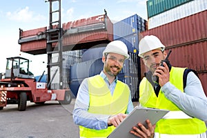Dock worker and supervisor checking containers data