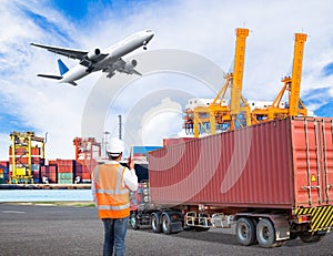 Dock worker talking on the walkie-talkie for controlling loading photo