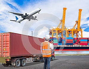 Dock worker talking on the walkie-talkie for controlling loading photo