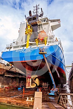 Dock workers at work in a ship repair drydock in the Port of Rotterdam. Rotterdam, The Netherlands- September 5, 2015