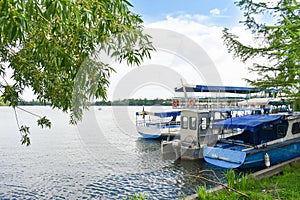 Docked boats on Herastrau Park Lake are waiting the tourists for sail