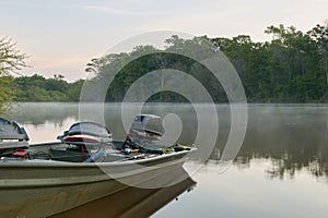 Docked river fishing boat and crisp sunrise mist