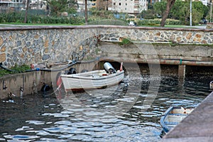 Docked Rowboat by Stone Wall