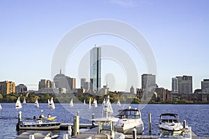 Docked sailing boats on a Charles River with view of Boston skyscrapers