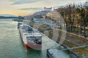 Docked ship at Danube river bank and Bratislava castle
