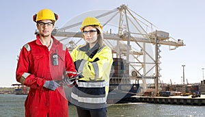 Dockers posing in front of a container ship