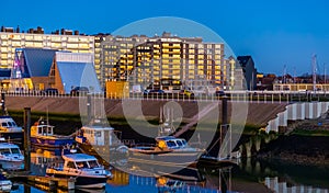 The docks in Blankenberge lighted at night, architecture and city scenery of a popular town in Belgium