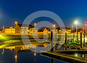 The docks of Blankenberge with view on the street and buildings, lighted city by night, Architecture of a popular city in Belgium