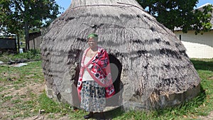 Doctor of African Medicine, in front of her small hut.