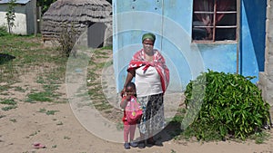 Doctor of African Medicine, in front of her small hut.