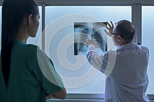 Doctor is analytic X-ray film , showing to patient , Health care concept