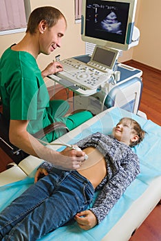 Doctor analyzing boy patient with abdomen