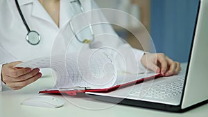 Doctor analyzing electroencephalogram, testing electrical activity of brain, EEG