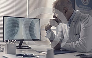 Doctor analyzing an x-ray image on the computer screen