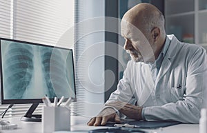 Doctor analyzing an x-ray image on the computer screen