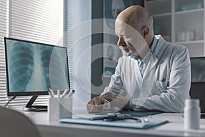 Doctor analyzing an x-ray image on the computer screen