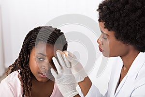 Doctor Applying Band Aid To Girl Head