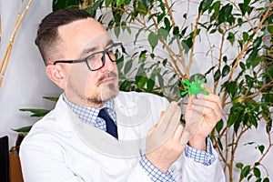 Doctor at appointment or scientist microbiologist virologist shows model of microorganism - virus prion or bacteria. Demonstration