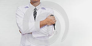 Doctor with arms crossed holding stethoscope isolated white background. Doctor standing with his arms and copy space.