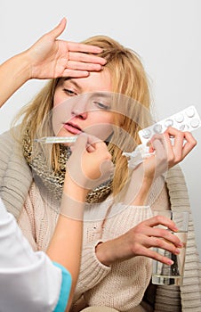 Doctor ask patient about symptoms. Flu and cold treatment. Woman consult with doctor. Girl in scarf examined by doctor