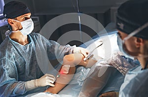 Doctor and an assistant in operating room for surgical clinic