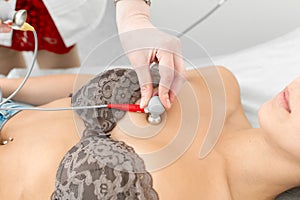 Doctor attaches ECG sensors to the patient chest
