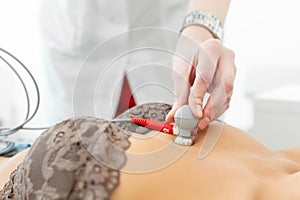 Doctor attaches ECG sensors to the patient chest