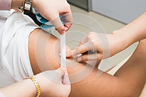 Doctor attaching a plaster onto patient arm after injection