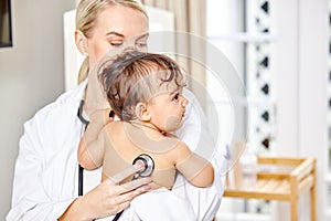 Doctor, baby and listen to lungs in hospital for newborn healthcare, medical appointment and stethoscope on body. Young