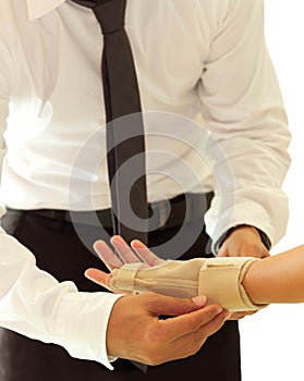 Doctor bandaging female broken hand