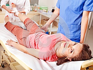 Doctor bandaging patient in hospital.