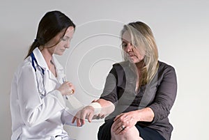 Doctor Bandaging Patient's Wrist