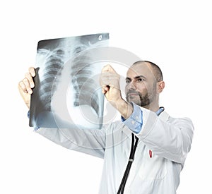 Doctor with beard and gown examines a chest x-ray