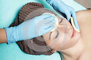 Doctor beautician cleanses skin woman with sponge. cosmetology treatment skincare face. Spa procedures