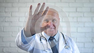 Doctor Behind a Protection Wall Gesticulate Putting His Hand on the Glass