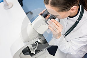 Doctor or biologist scrutinizing tissue under microscope