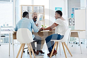 Doctor, black couple and holding hands in consultation, support and comfort in clinic. Healthcare, obstetrician and man