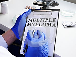 Doctor in gloves reads about Multiple myeloma