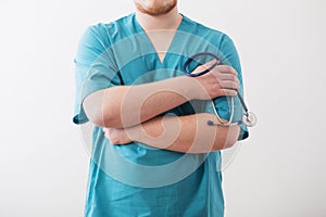 the doctor in blue uniform with stethoscope on white background