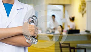 Doctor with blurred hospital counter and nurses.