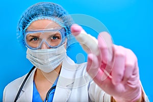 A doctor with a bottle of sanitizer sprays the liquid for disinfection. The concept of compliance with hand hygiene for patients