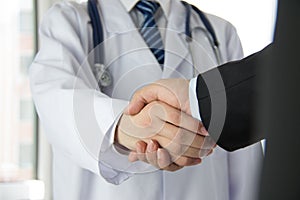 Doctor and businessman shaking hands