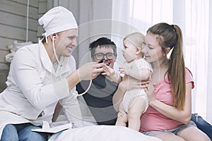 Doctor challenges and treats a small child in a room