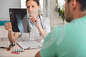 Doctor checking the ankle X-ray